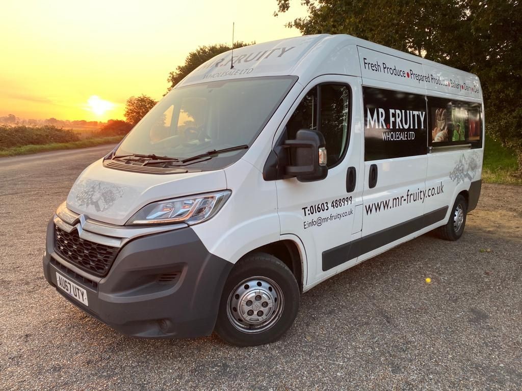 White van with mr fruity wholesale logo in front of a sunset